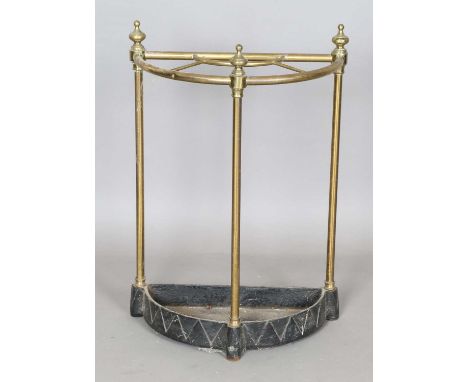 An Edwardian brass and cast iron demi-lune stick stand, height 60cm, width 41cm.