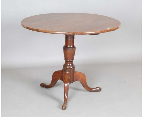 A 19th century provincial oak circular tip-top wine table, on tripod legs, height 72cm, diameter 90cm.