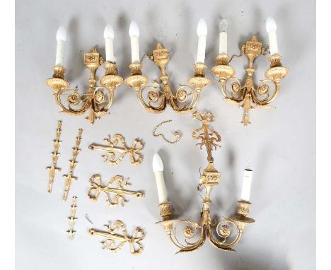 A set of four 20th century French cast gilt metal twin-light wall sconces of Neoclassical form, height 55cm (faults).