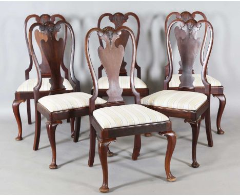 A set of six early 20th century Queen Anne style walnut dining chairs, the vase backs carved with scallop shells, height 107c