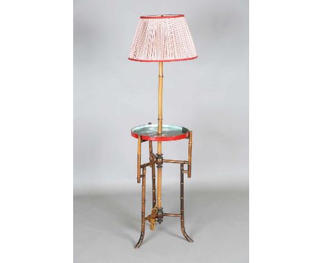A late 19th/early 20th century bamboo lamp standard with pleated cotton shade and a circular tier painted with a hunting scen