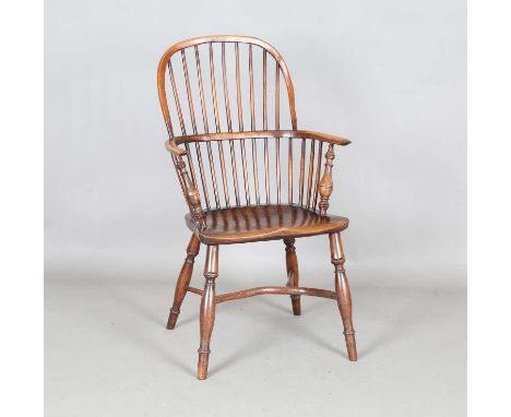 A mid-19th century yew and elm stick back Windsor armchair with crinoline stretcher, height 100cm, width 58cm, depth 60cm.