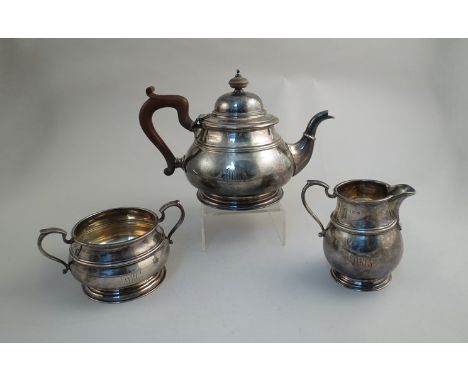A Mappin & Webb silver three piece tea service, bakelite knop and handle, circular stepped base, Birmingham 1923, monogrammed