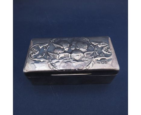 A William Comyns silver rectangular trinket box with cherub embossed top, London 1901, lined interior (slight dents),  12cm l