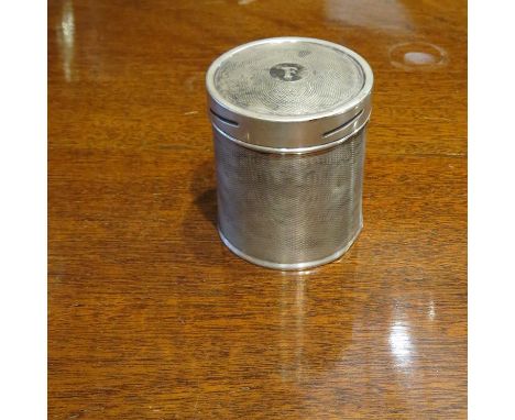 A Mappin & Webb silver engine turned cylindrical tea caddy, Sheffield 1946, dented and monogrammed "F", 114g
