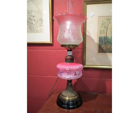 An Edwardian oil lamp converted to electricity, hand painted opaque glass reservoir with black ceramic base 