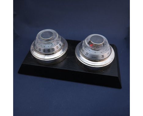 A Tiffany & Co sterling silver thermometer and barometer circa 1960's Honeywell, mounted on ebonised wooden base 