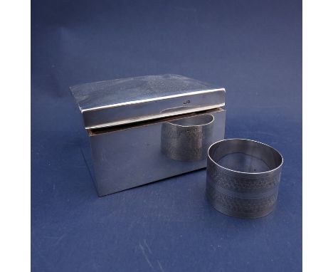 A silver cigarette box, Chester marks rubbed, dented, and a silver engine turned napkin ring (2) 