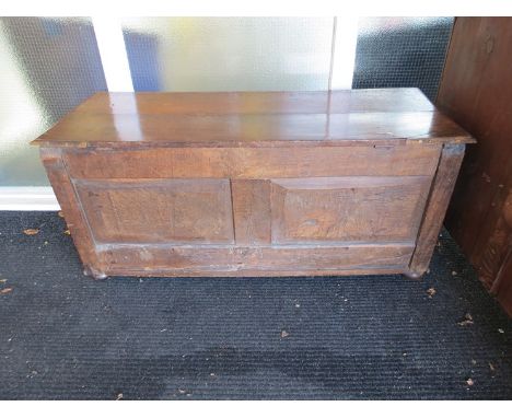 A 17th Century three panel oak coffer on bun feet with later alterations, 124cm long