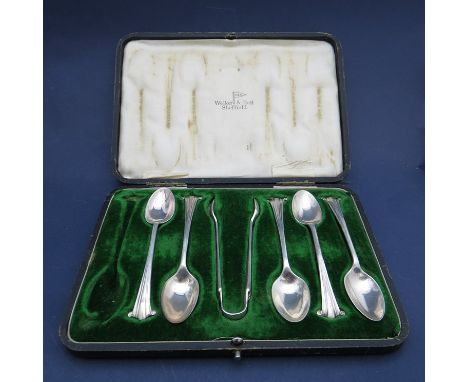 A part set of silver tea spoons and tongs, retailed by Walker & Hall, Sheffield 1917 (one spoon missing) cased, 93g