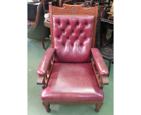 A pair of Edwardian button back maroon leather library chairs