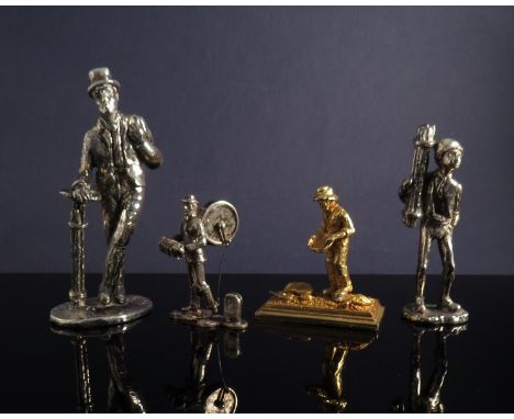A white metal figure of a chimney sweep together with chimney "lad", a similar ornate figure of a one man band and a yellow m