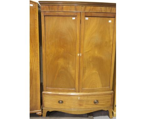 Edwardian mahogany combination wardrobe, bow fronted with two doors above a single long drawer. Not available for in-house P&