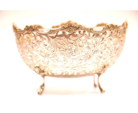 London imported hallmarked silver glass lined sweetmeats bowl, the silver body raised on four clawed supports, pierced and de