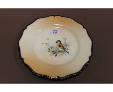 A ROYAL WORCESTER HAND PAINTED CABINET PLATE, central decoration depicting a bird with blossom and foliage, a second bird in 