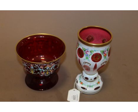 A BOHEMIAN WHITE OVERLAY CRANBERRY GLASS GOBLET, with hand painted floral and gilt enamel decoration, H 17.2 cm, together wit