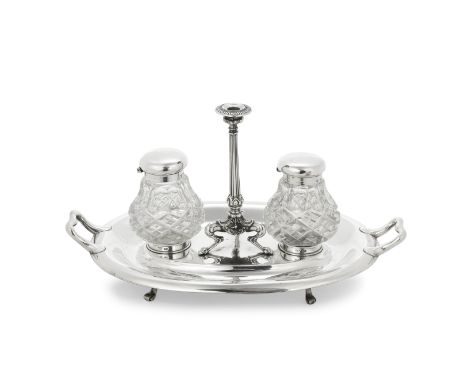 A Victorian silver inkstandHenry Wilkinson, London 1876 Oval, with two cut-glass ink pots and a central taperstick, length 30