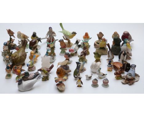 A large collection of ceramic birds including Royal Worcester, Doris Lindner for Royal Crown Staffordshire yellow throated wa