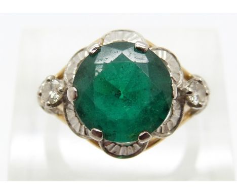 A yellow metal ring set with a synthetic emerald and two diamonds, size K 