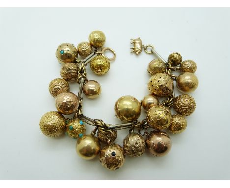 A bi-coloured bracelet with 25 sphere / orb charms including a Masonic charm, turquoise set with engraved decoration, a vinai