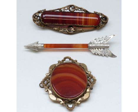 A Victorian silver brooch in the form of an arrow (10.5cm long) set with carnelian agate and two other Victorian agate brooch