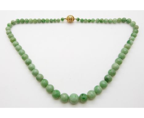 A jade necklace made up of spherical graduated beads with a filigree clasp