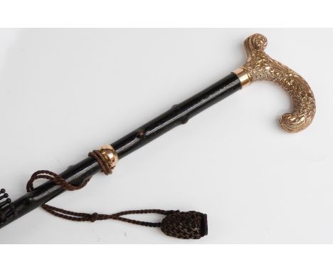 A late 19thC/20thC parasol with yellow metal crook handle, suspension collar and ebonised briar stick, 93cm