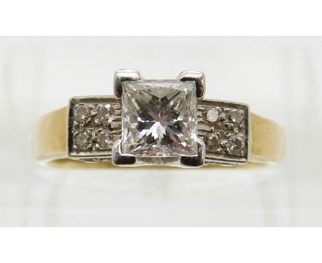 A 18ct gold ring set with a princess cut diamond of approximately 0.6ct and four diamonds to each shoulder in a platinum sett