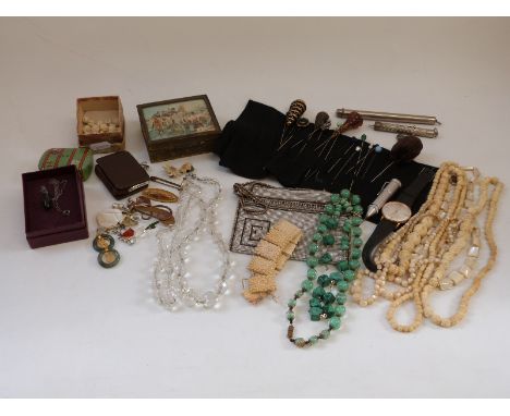 A collection of costume jewellery including a Victorian banded agate hat pin, jadeite pendants, silver hat pin, carved bone, 