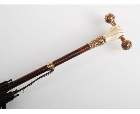 Victorian parasol, the handle an 18ct gold plated and ivory fist holding a bar representing solidarity, with yellow metal sus