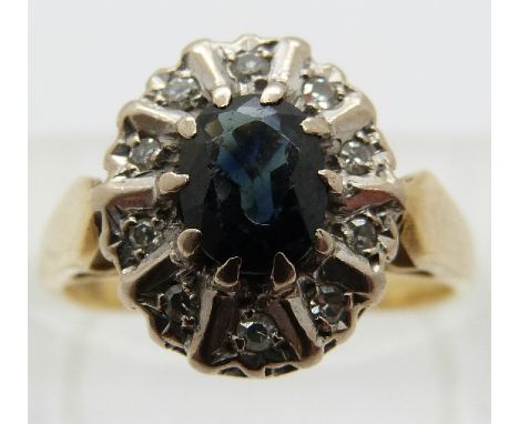 An 18ct gold ring set with a sapphire surrounded by diamonds, size J/K