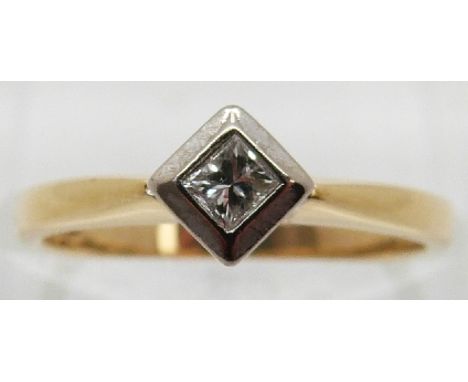 An 18ct gold ring set with a princess cut diamond in a platinum setting, size K 