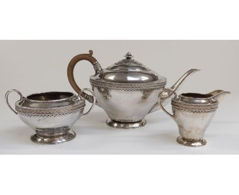 Harold Edwin Landon of Lancaster, Arts and Crafts hallmarked silver three piece teaset with hammered decoration, height of te