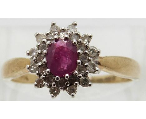 A 9ct gold ring set with an oval ruby surrounded by diamonds, size Q 