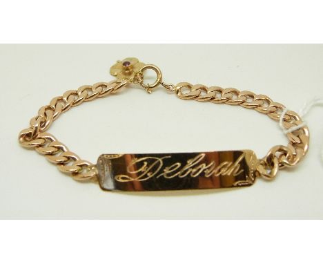 A yellow metal identity bracelet with gold flower charm set with a ruby, 11g 