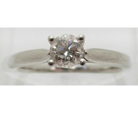 A platinum ring set with a round brilliant cut diamond of approximately 0.5ct, size K 