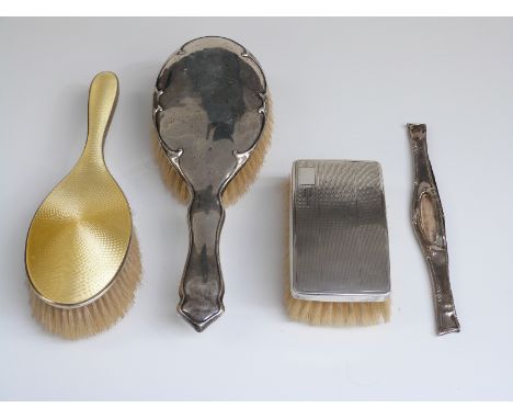 Yellow guilloché enamel and hallmarked silver handled brush, two further hallmarked silver mounted brushes and a silver comb 