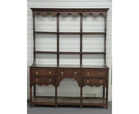 Georgian oak dresser with plate rack top, the base fitted five drawers above shelf supported on turned legs W164 x D48 x H202