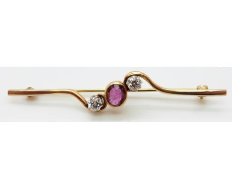 An 18ct gold brooch set with an oval ruby of approximately 0.5ct and two diamonds each approximately 0.25ct, L6.3cm