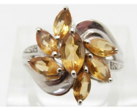 A 9ct white gold ring set with citrine and diamonds in a floral cluster, size K/L