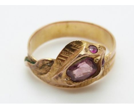 A yellow metal ring in the form of a snake set with an amethyst and ruby eyes, size S 
