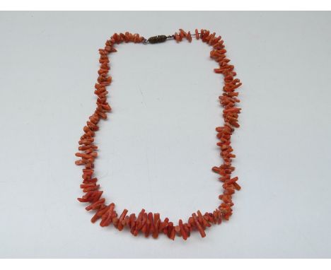 A coral necklace made up of irregular pieces 