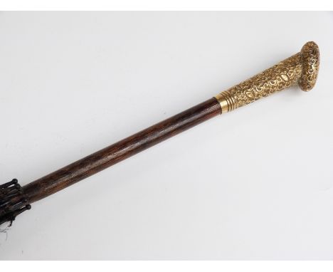 A late 19thC/20thC parasol with yellow metal handle in the form of a heart, with vacant cartouche and hardwood stick