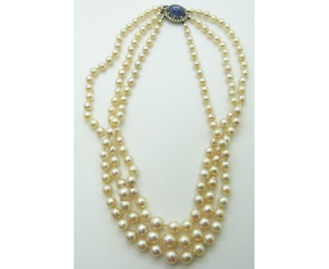 A three-strand pearl necklace, the white gold clasp set with a 12ct natural untreated Sri Lankan star sapphire surrounded by 