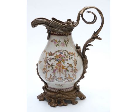 A large ceramic jug with brass fittings, 39cm tall