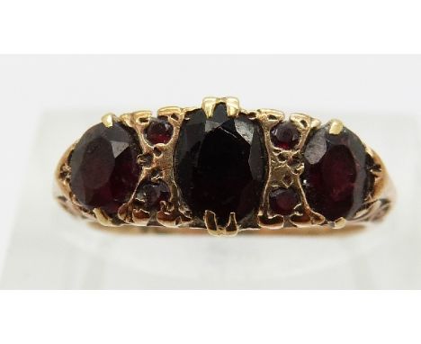 A 9ct gold ring set with garnets, size K