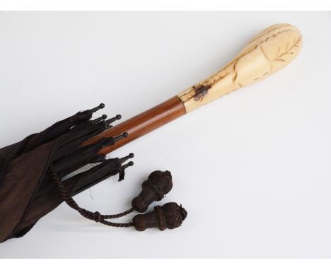 A 19thC/20thC parasol with carved ivory handle with vacant cartouche on hardwood stick, 87cm