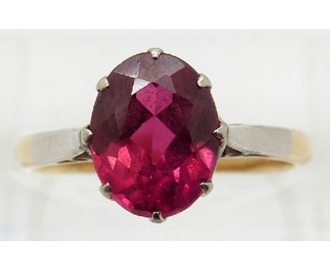 An 18ct gold ring set with an oval cut synthetic ruby, size K 