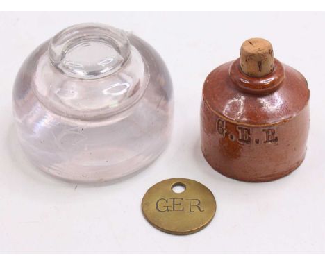 Two Great Eastern Railway inkwells, to include a glass inkwell, measuring 3 inches in diameter, and a porcelain inkwell, stam