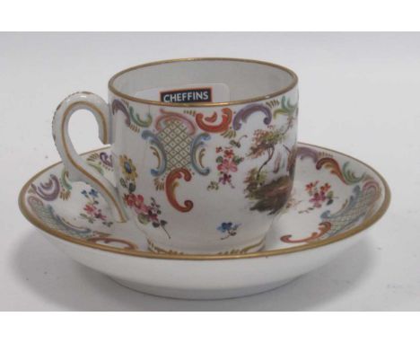 A Veuve Perrin porcelain coffee cup and saucer, circa 1760, painted with river and coastal landscapes within acanthus borders
